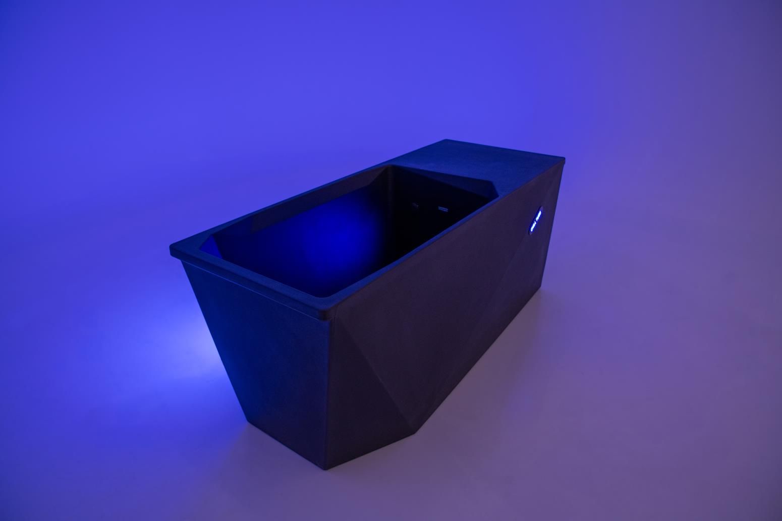 Black rectangular container with a light blue glow.
