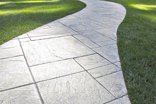 Tiled pathway in the middle of a lawn or landscape