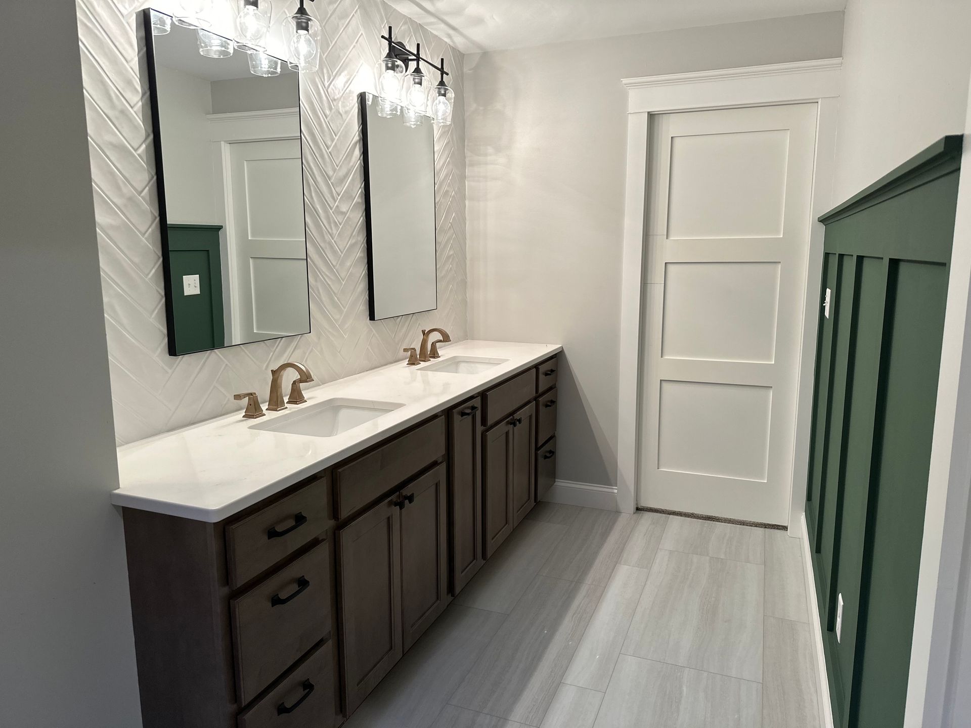 a bathroom with two sinks and two mirrors