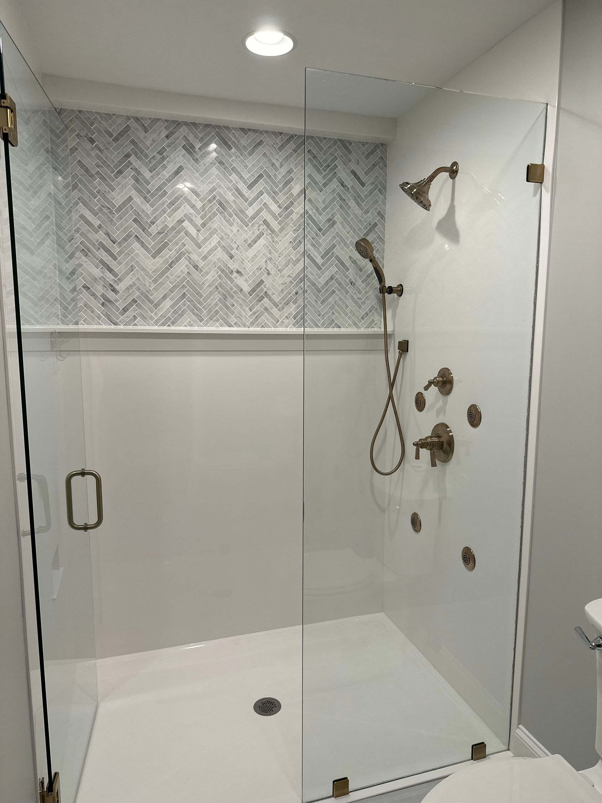 a bathroom with a walk in shower and a toilet
