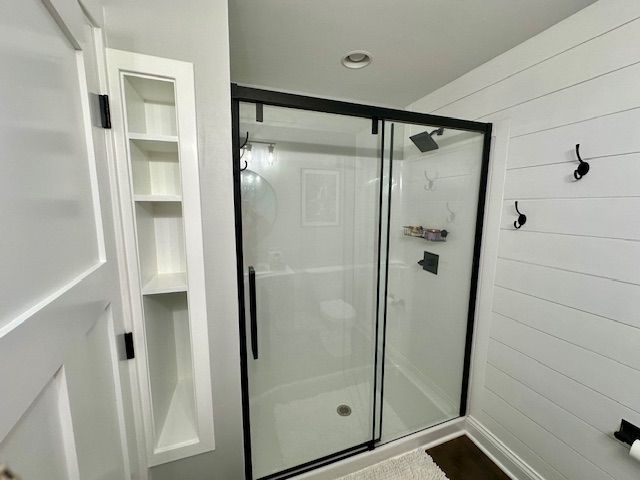 a bathroom with a sliding glass shower door