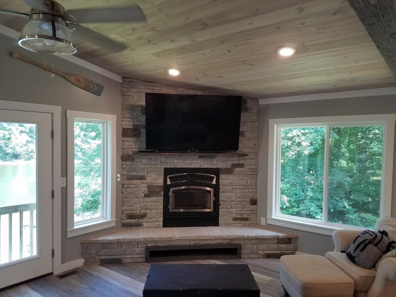 house indoor with wooden ceiling, television and sofa