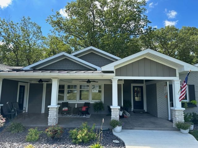 a house with a porch and an american flag on it