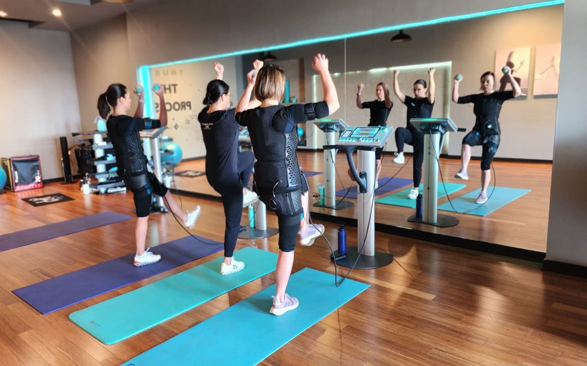 People working out using EMS training suits inside a fitness studio in Schaumburg IL