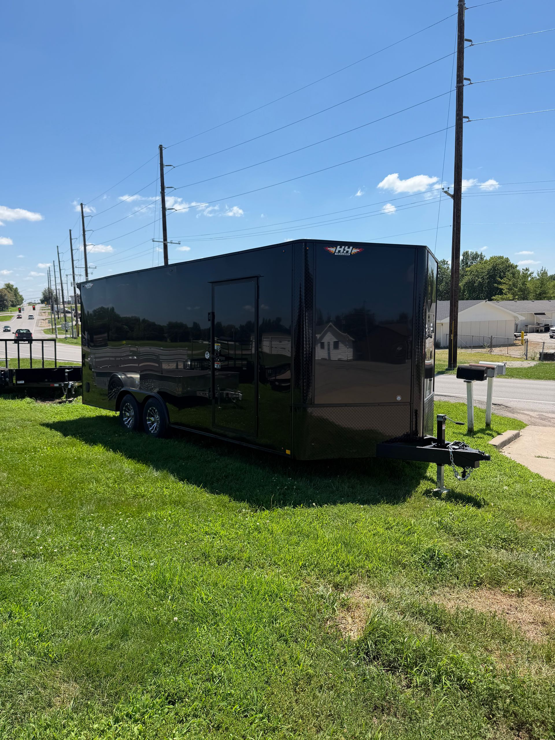 Black enclosed cargo trailer with two wheels and a side door