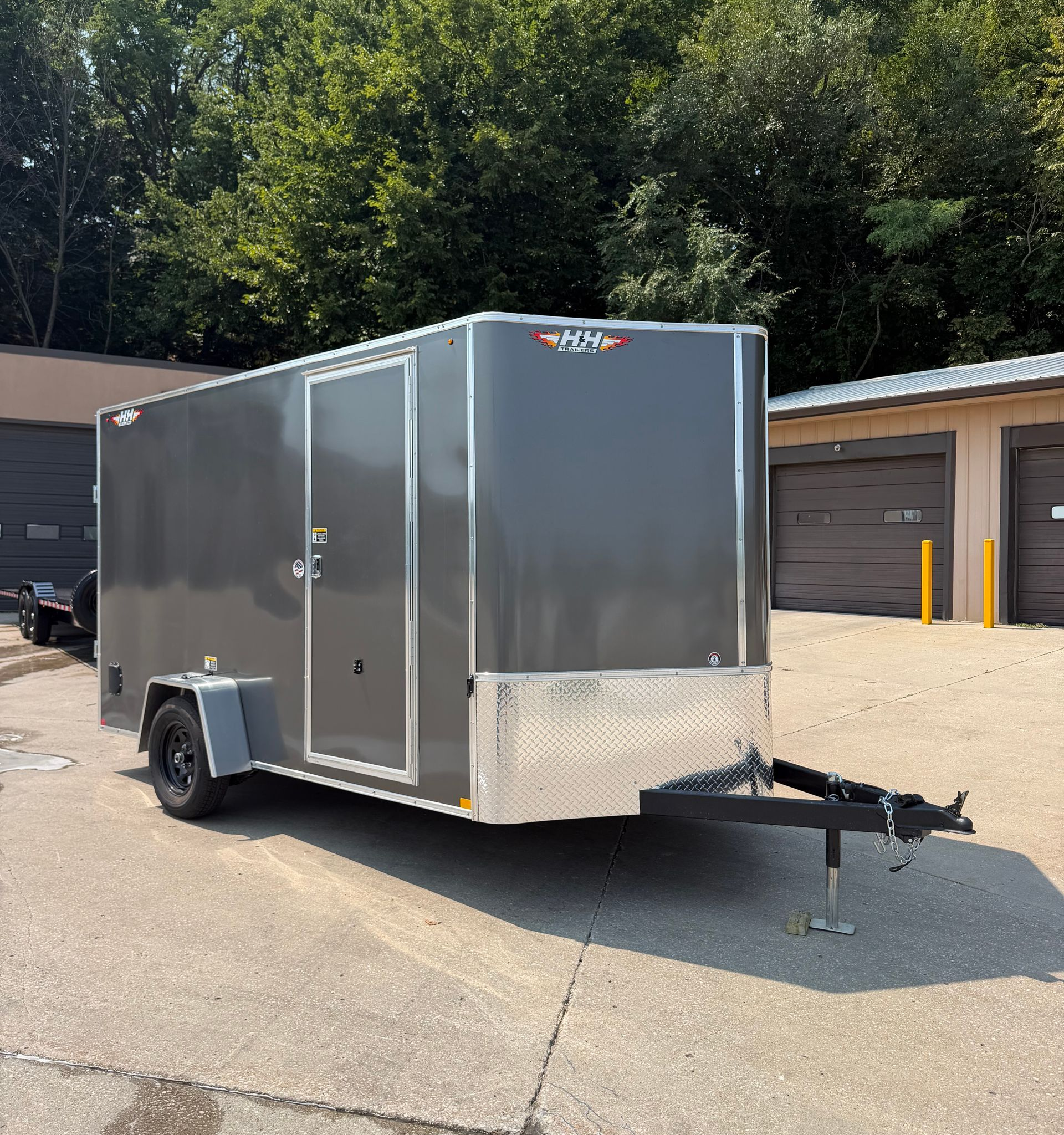 Enclosed cargo trailer, silver and black, with a door