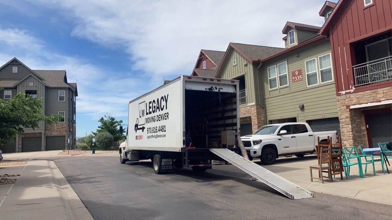 A moving truck is parked in front of a house.