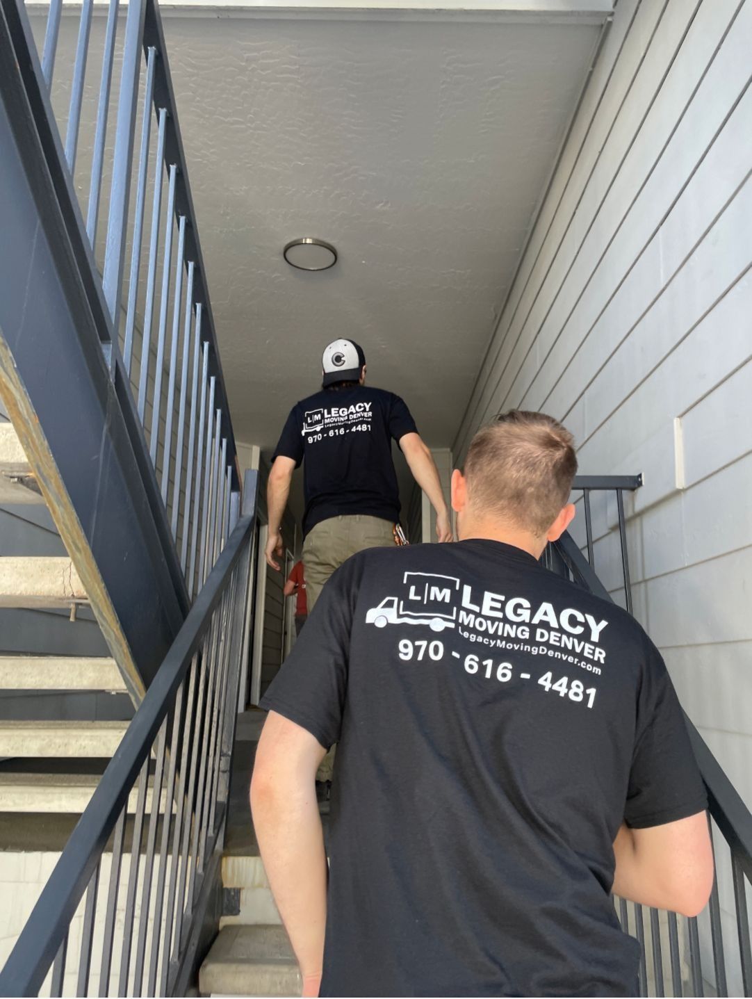 Two men are walking up a set of stairs.