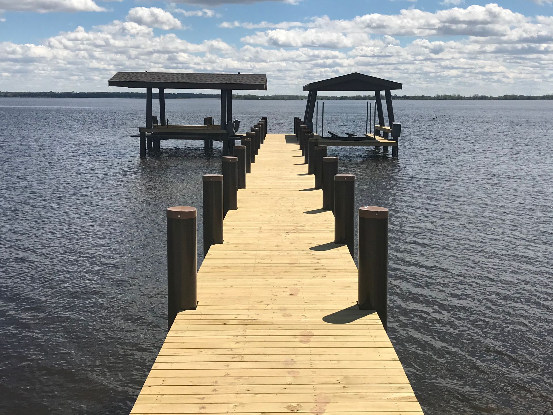 A boat is tied to a dock on a lake