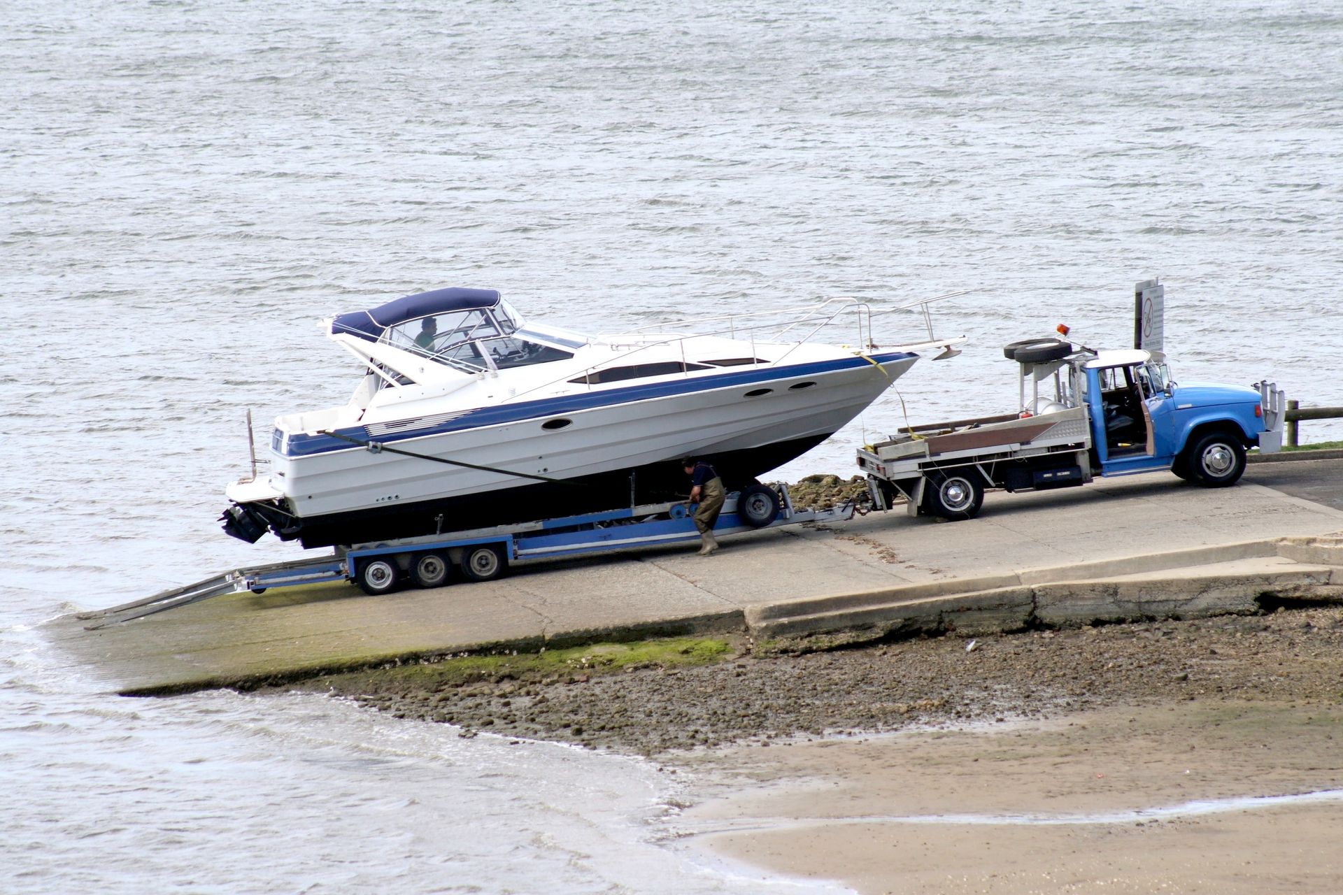 A boat is being towed by a truck into the water