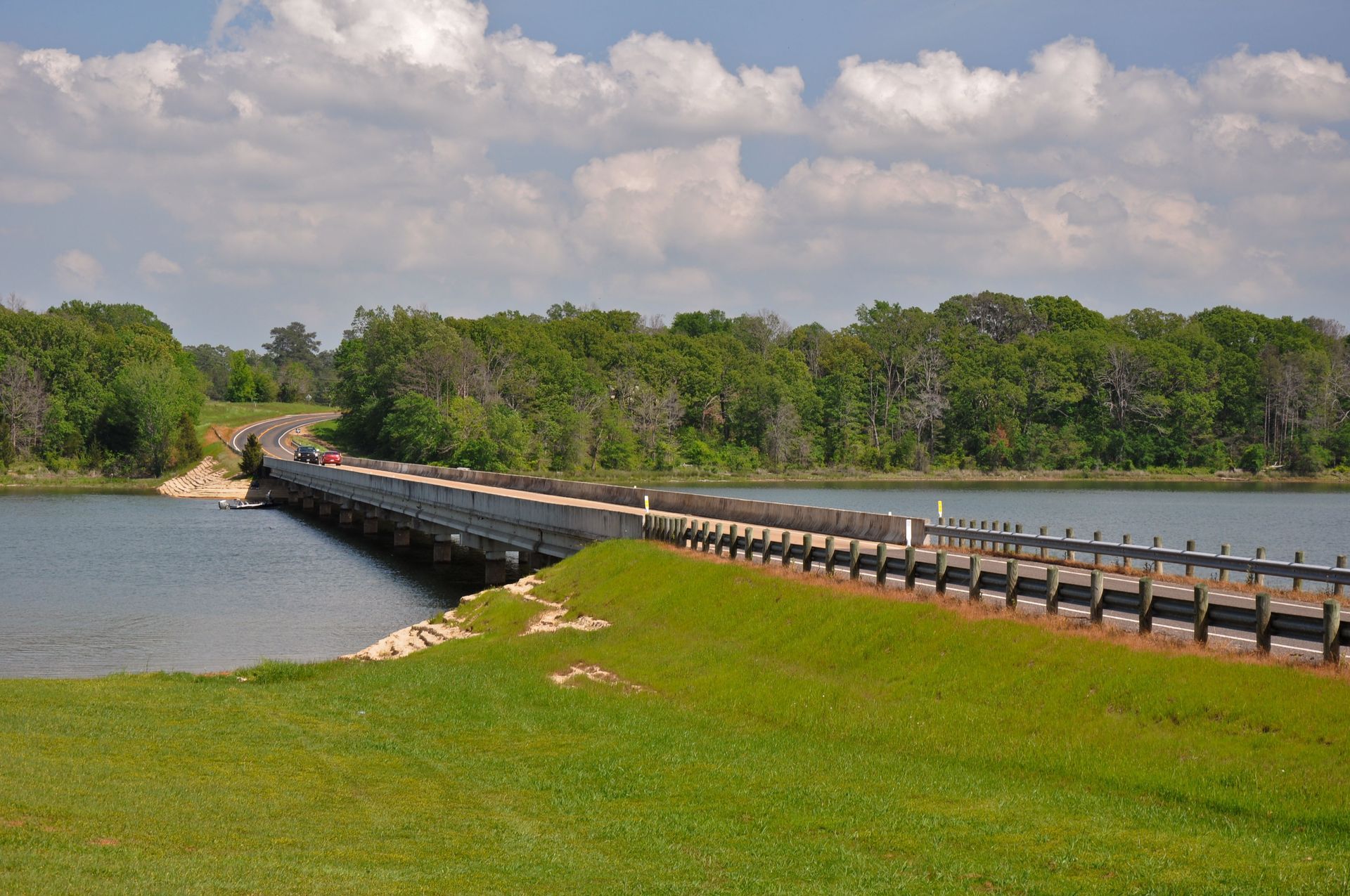 A bridge over a body of water with trees in the background