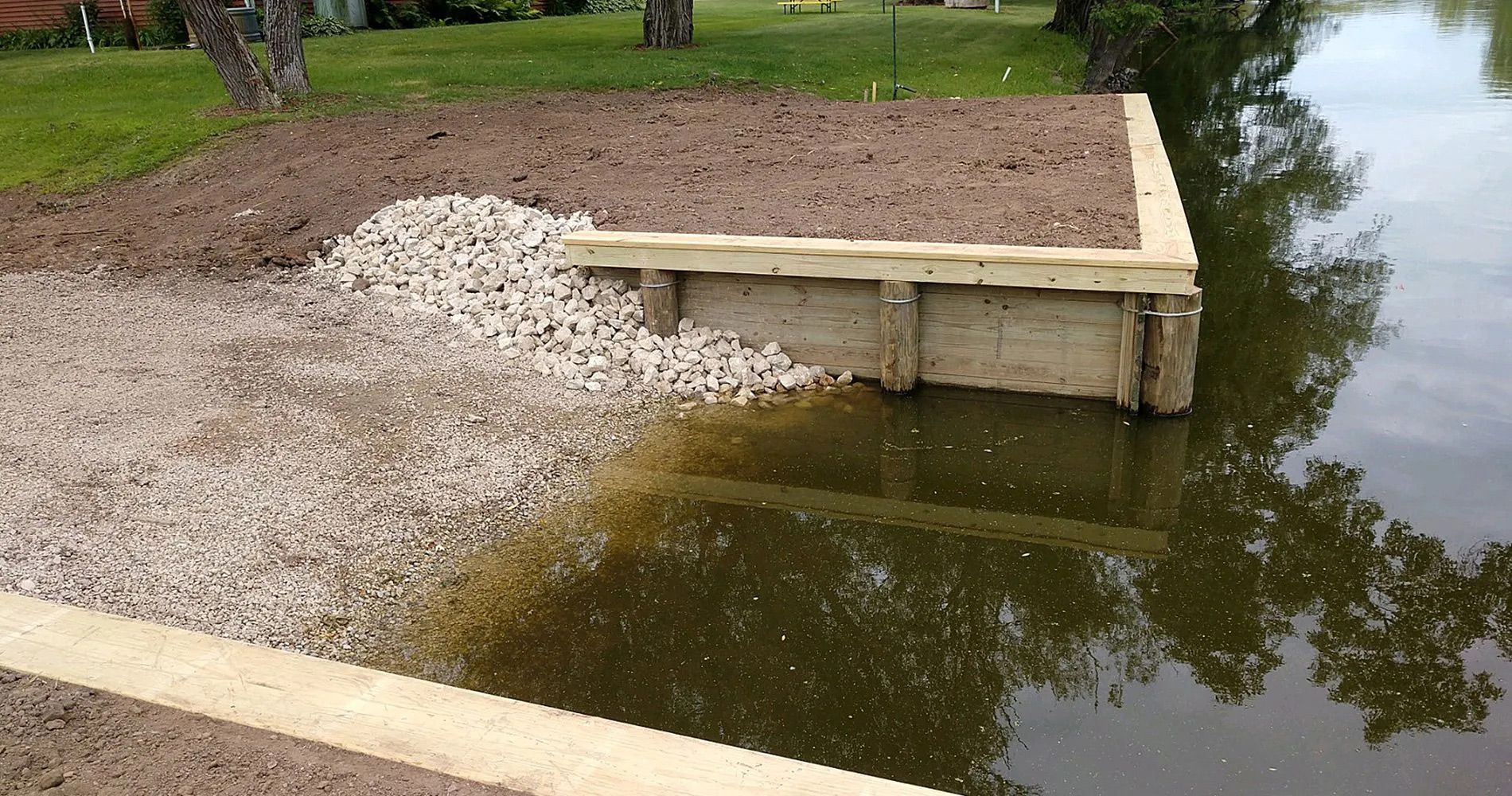 A wooden dock sits next to a body of water