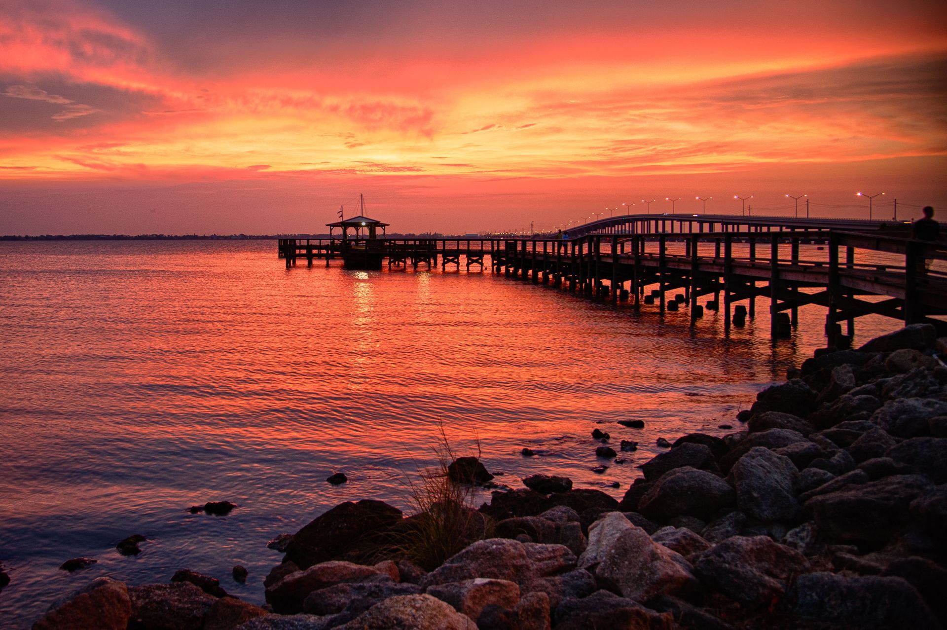 A pier overlooking a body of water at sunset