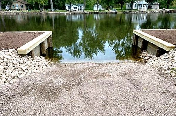 A large body of water with a dock in the foreground