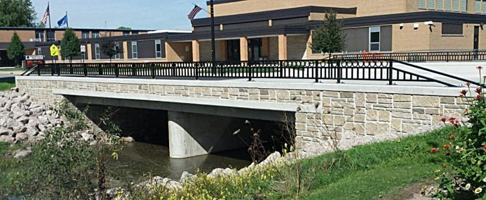 A bridge over a river in front of a building