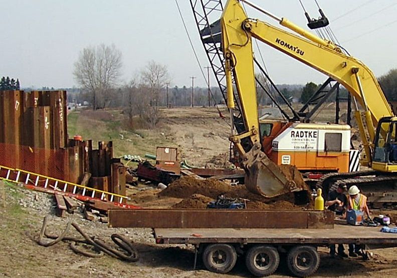 A komatsu excavator is digging a hole in the ground