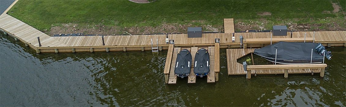An aerial view of a dock with two boats docked at it.