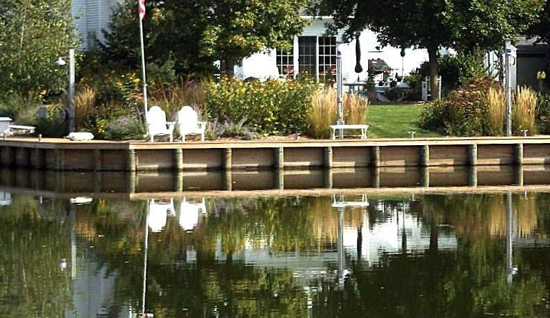 A large body of water with a house in the background