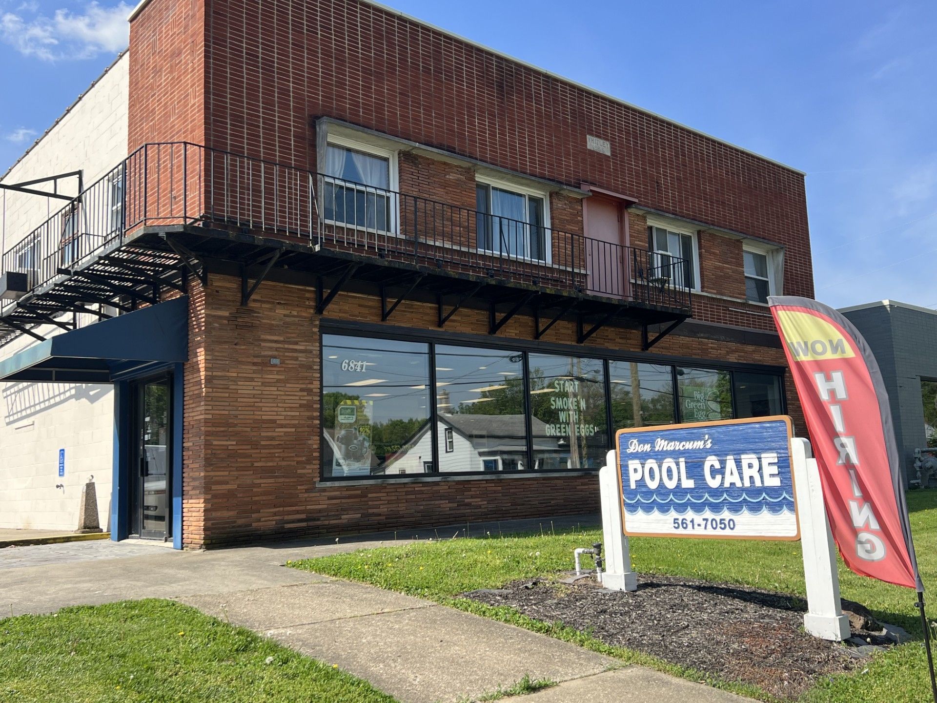 Brick storefront with blue awning and sign
