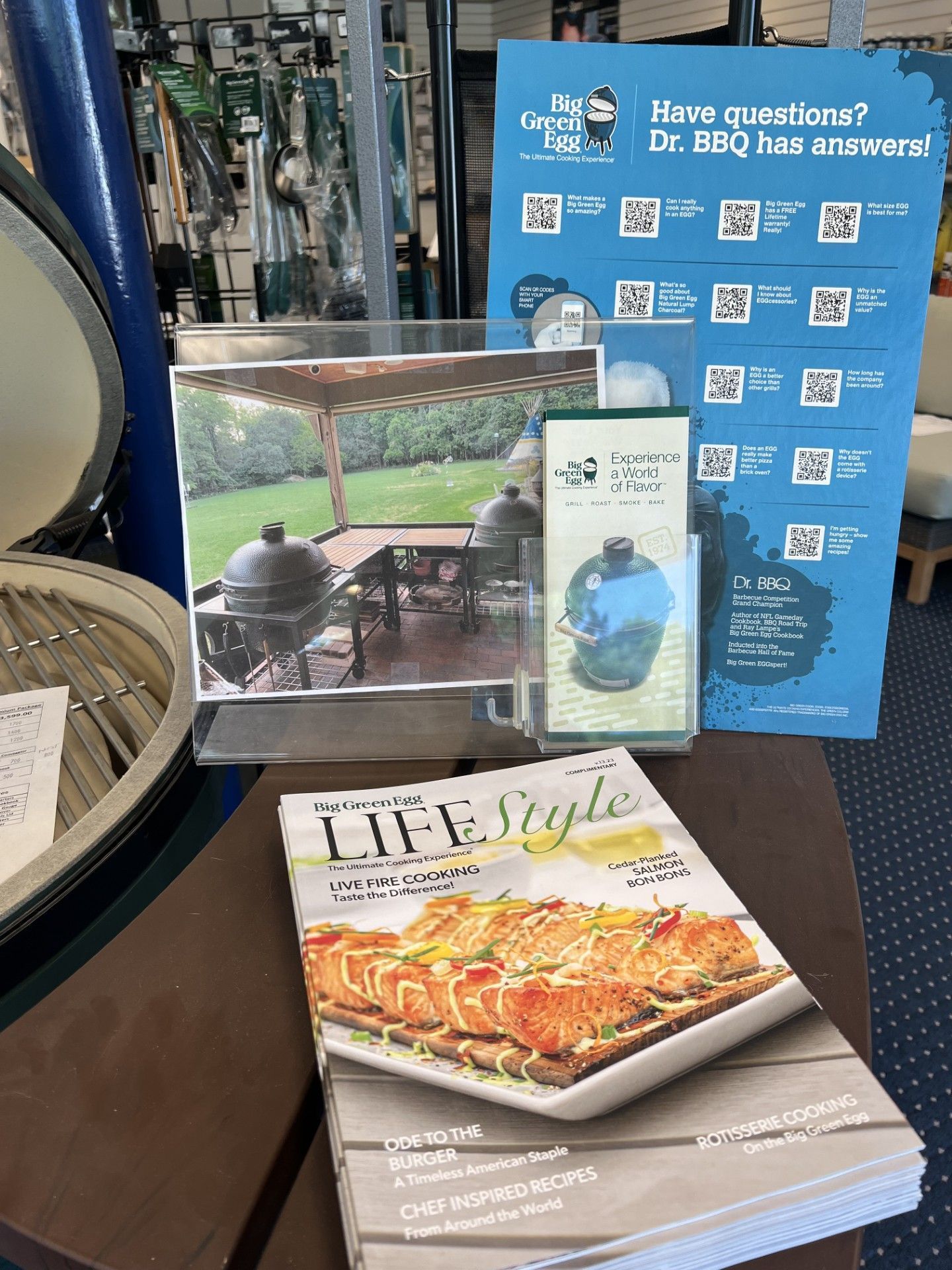 Brochure display with travel guides, including a lifestyle magazine and a blue hotel information sign
