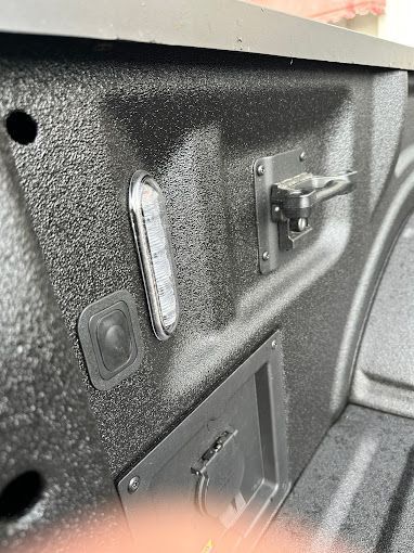 A close up of the back of a truck bed with a light on it.