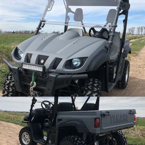 A yamaha atv is parked on a dirt road