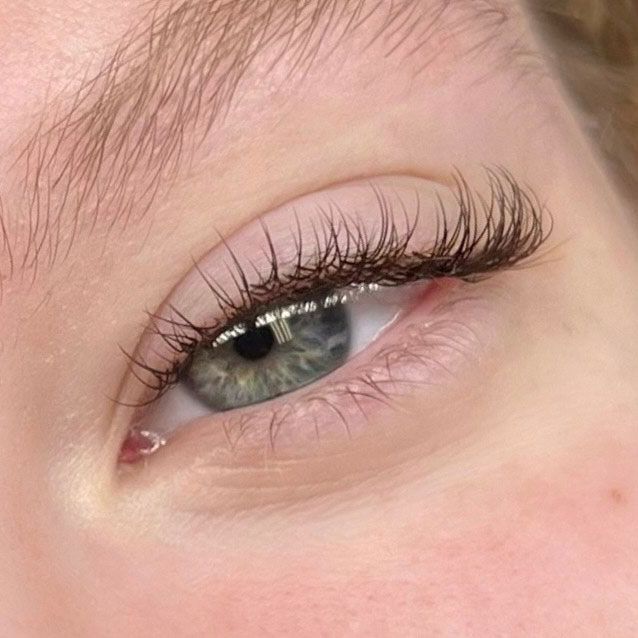 A close up of a woman's eye with long eyelashes