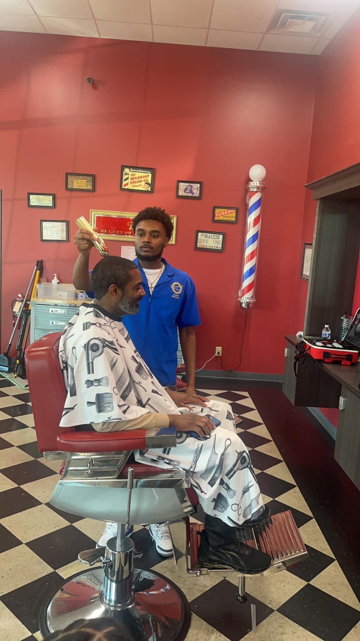 a man is getting his hair cut at a barber shop .
