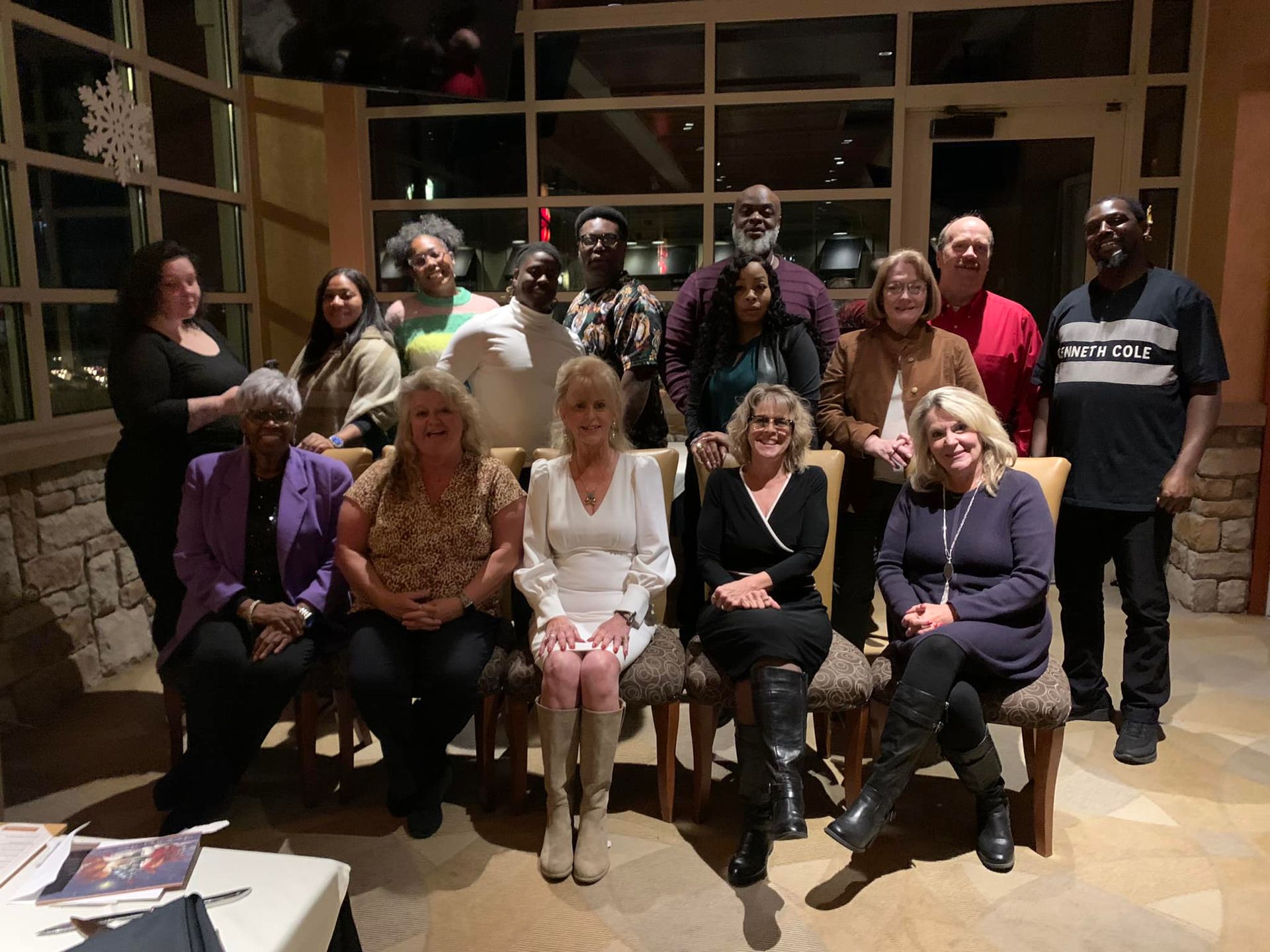 a group of people are posing for a picture in a room .