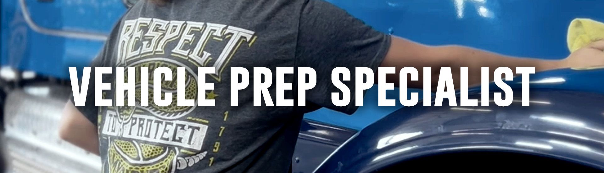 A person washes the blue exterior of a semi-truck. A Peterbilt logo is visible on the truck.