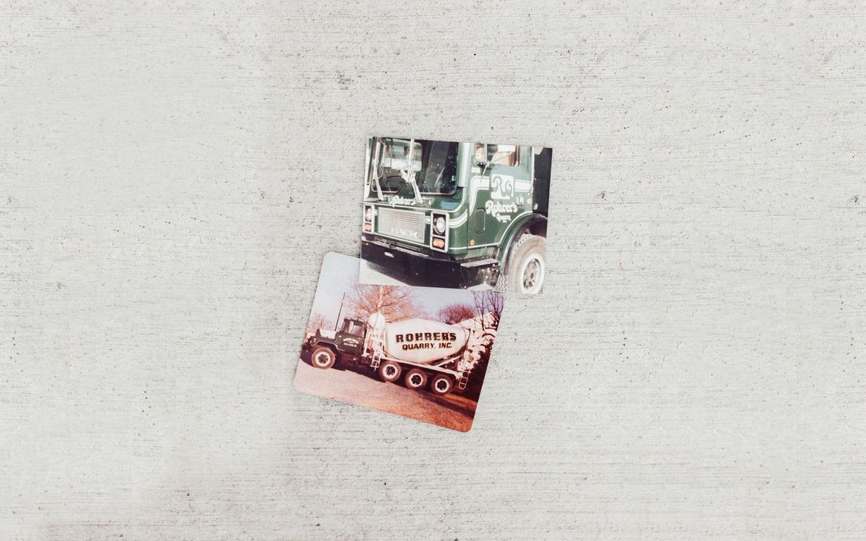 A pop-up card of a green truck with an image of a tanker truck below it, on a white surface.