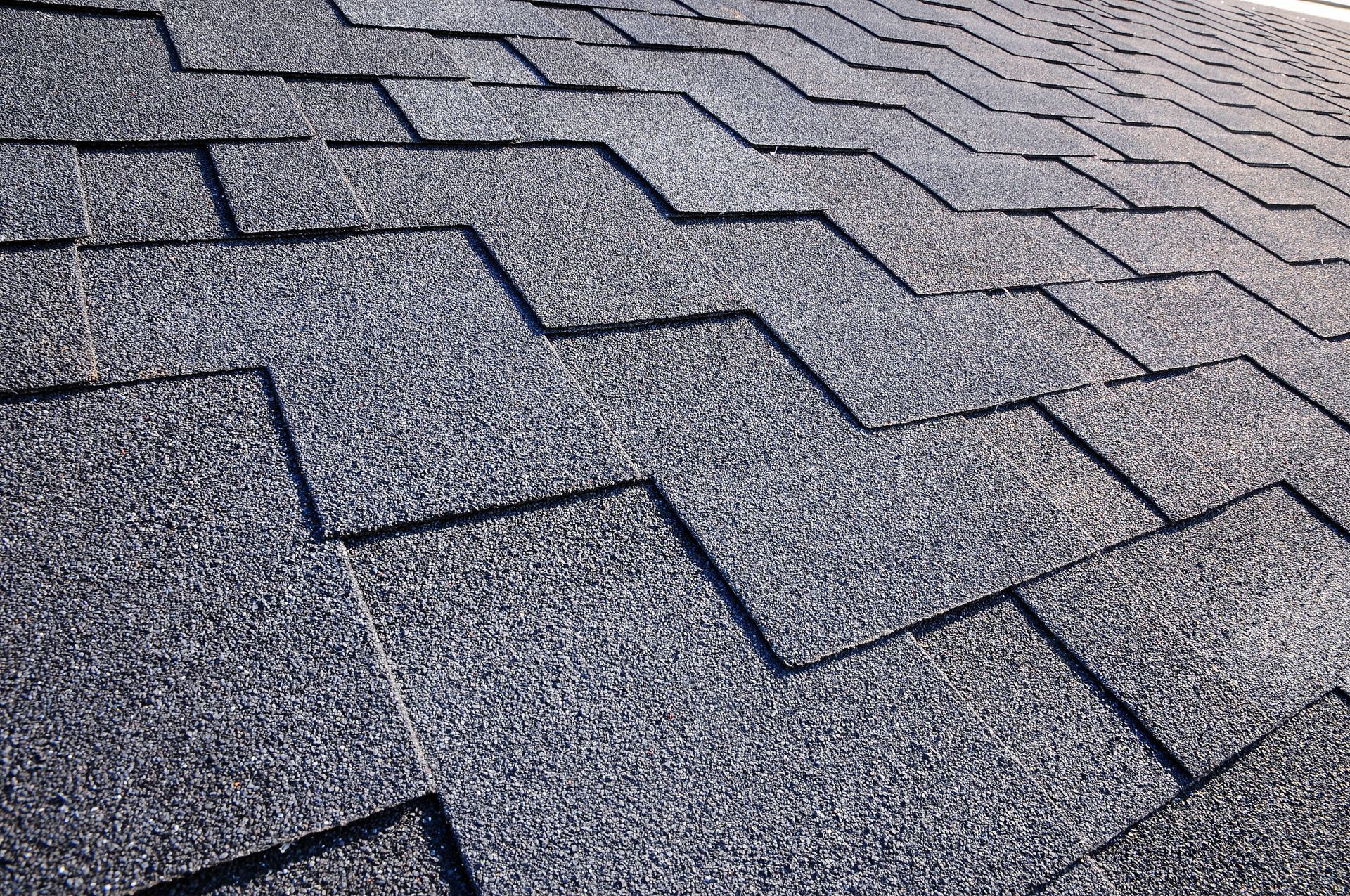 Close-up view of a dark gray asphalt shingle roof.