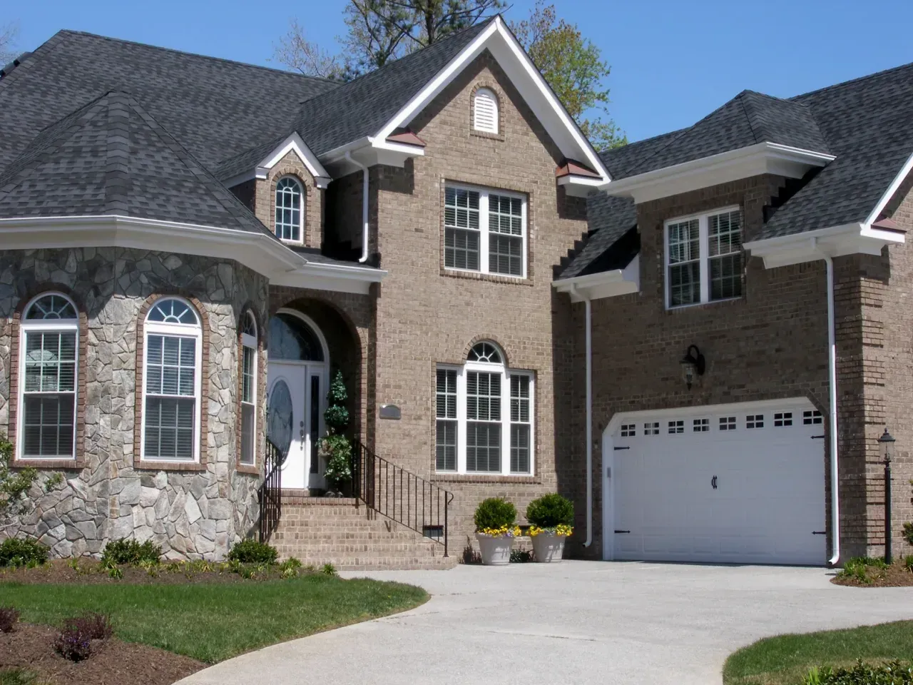 A large brick house with a white garage door