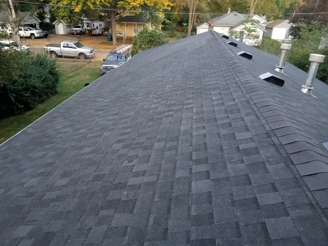 The roof of a house has a lot of shingles on it.