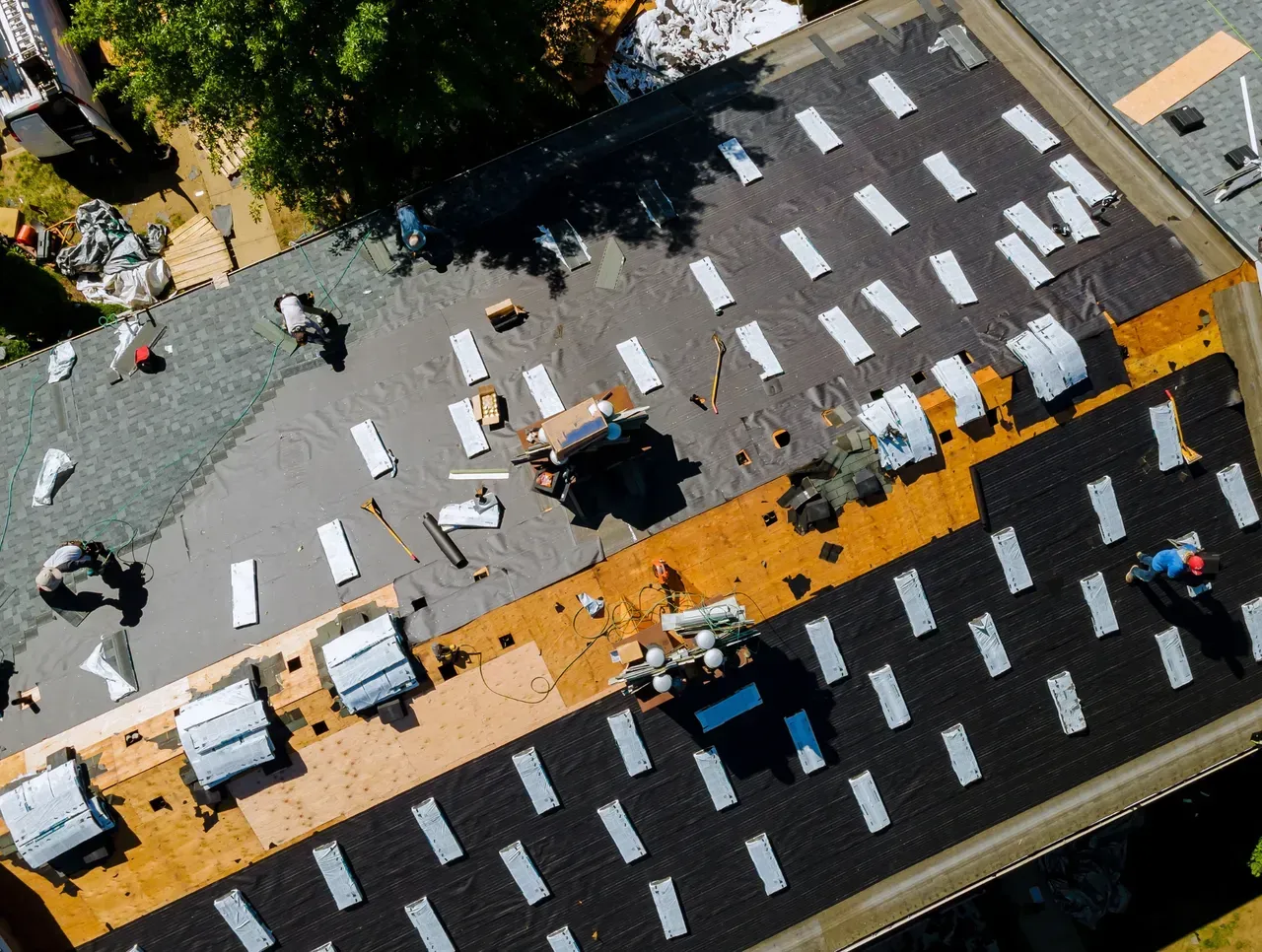 An aerial view of a roof being installed on a house.