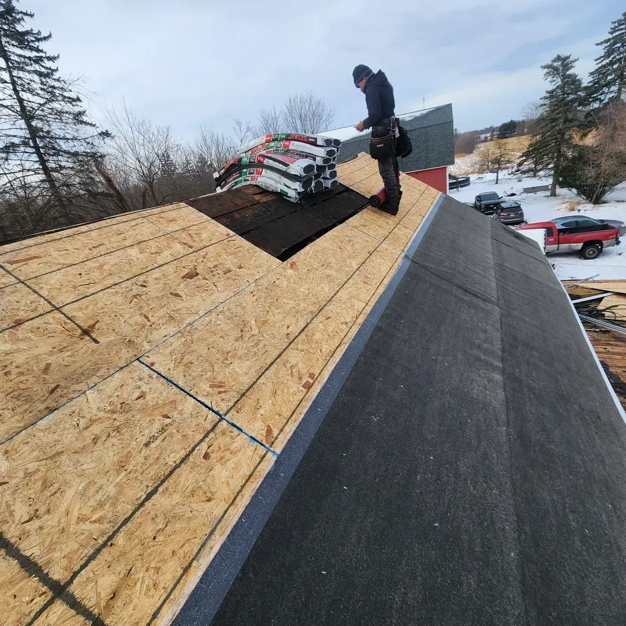 A man is working on the roof of a building