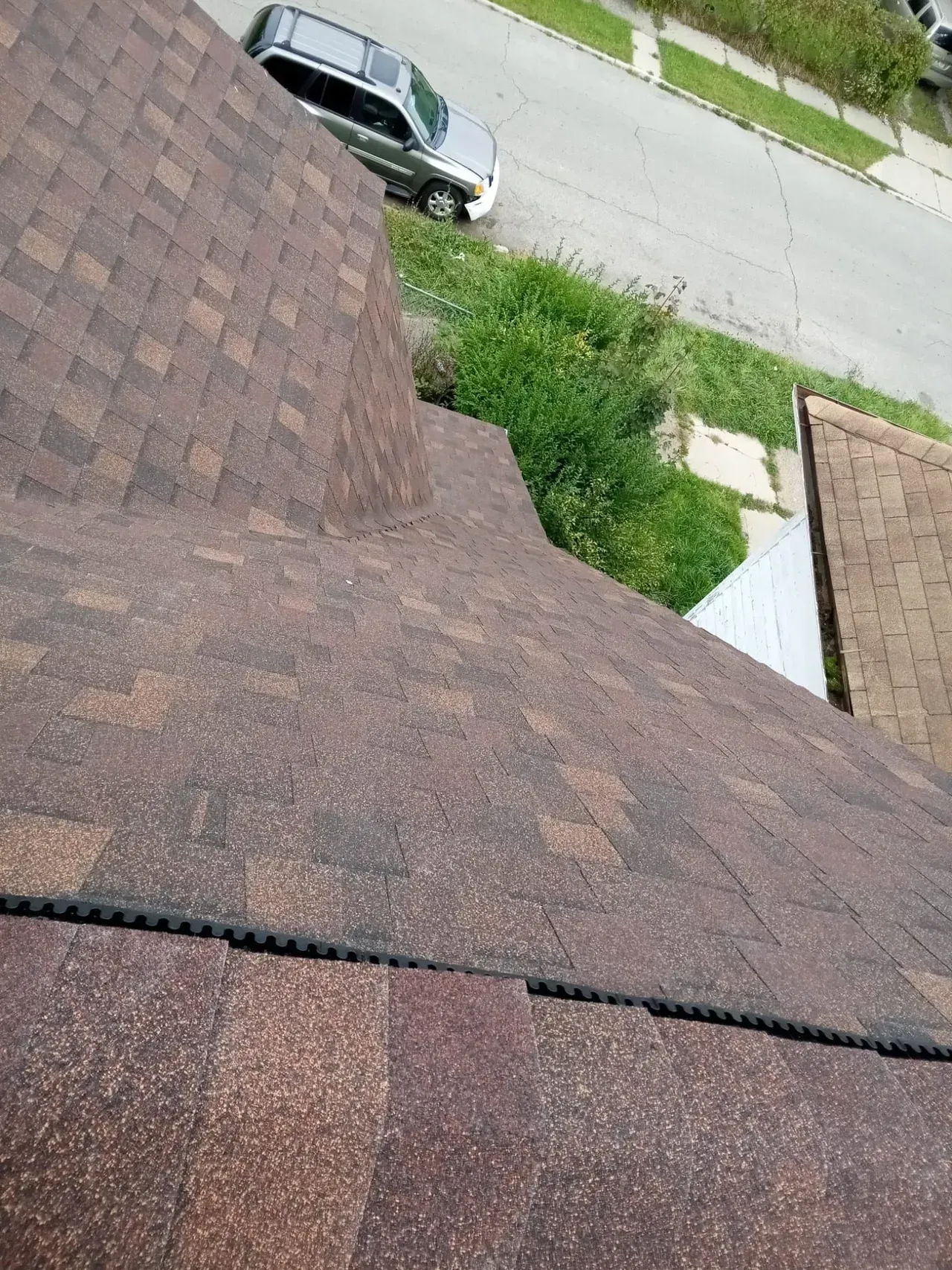 A car is parked on the roof of a house.