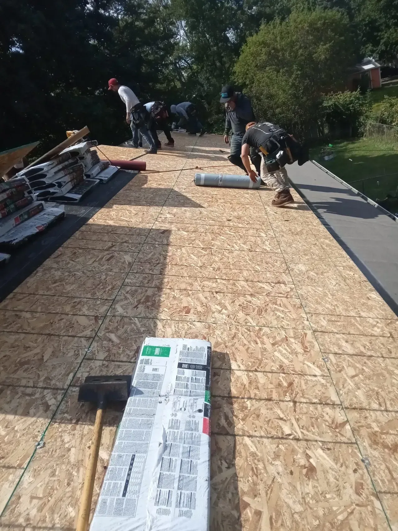 A group of people are working on a roof.