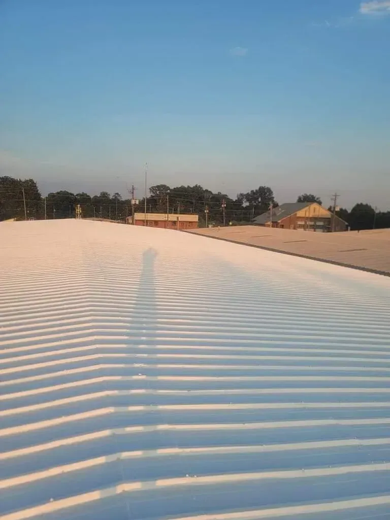 A large white roof with a blue sky in the background.