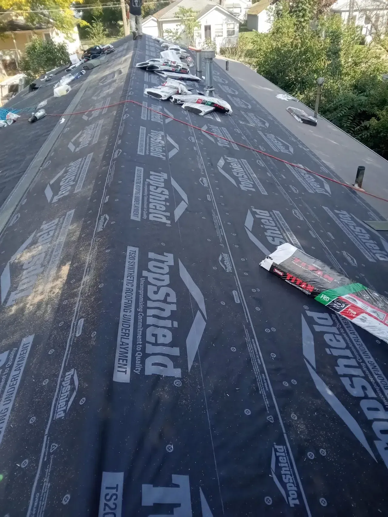 A roof with a lot of roofing material on it.