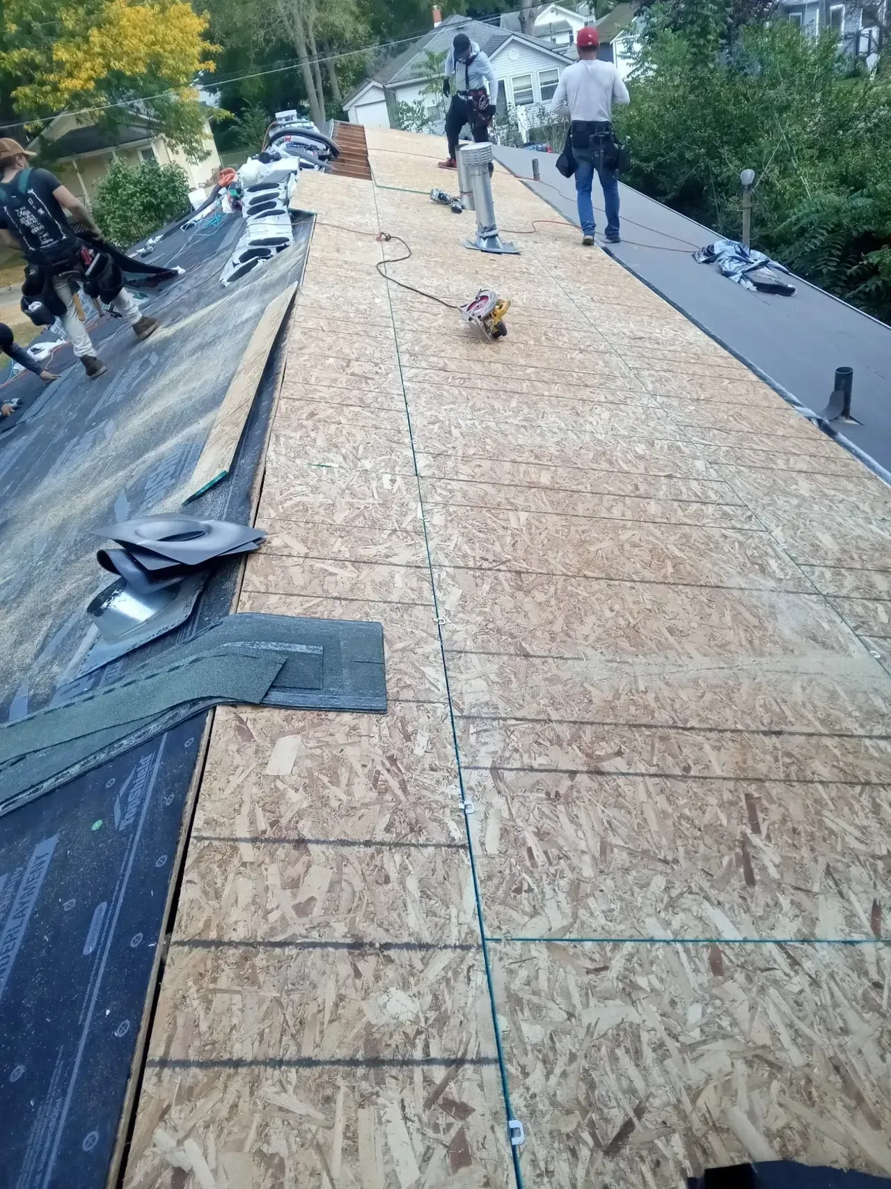 A group of people are working on a roof.