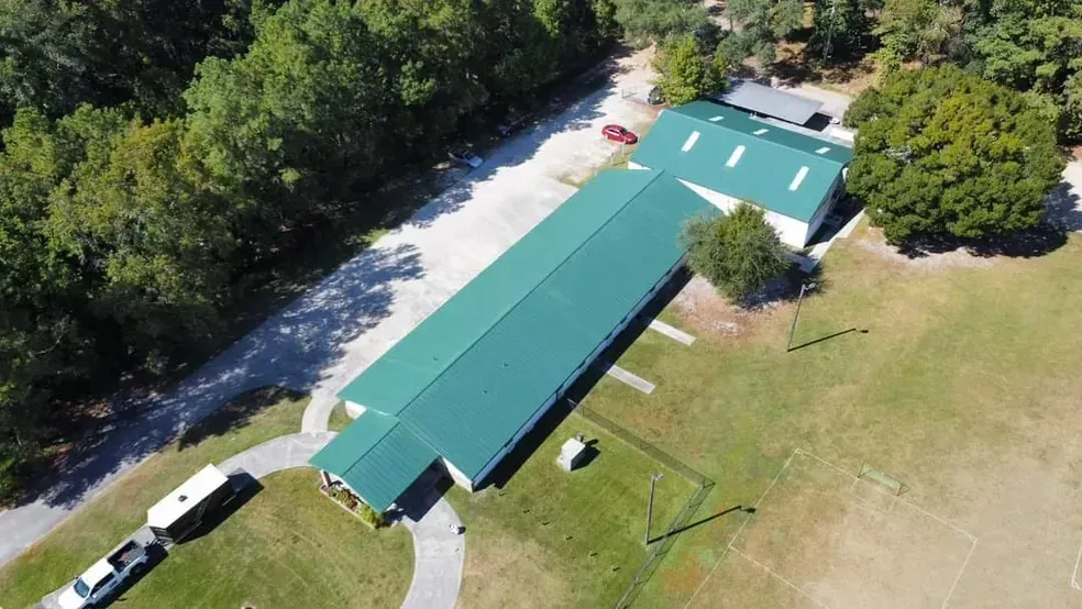 An aerial view of a large building with a green roof