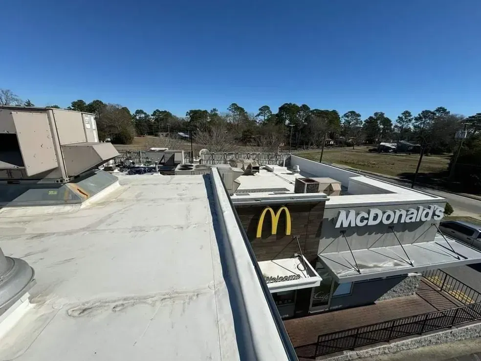 An aerial view of a mcdonald 's restaurant on a sunny day.