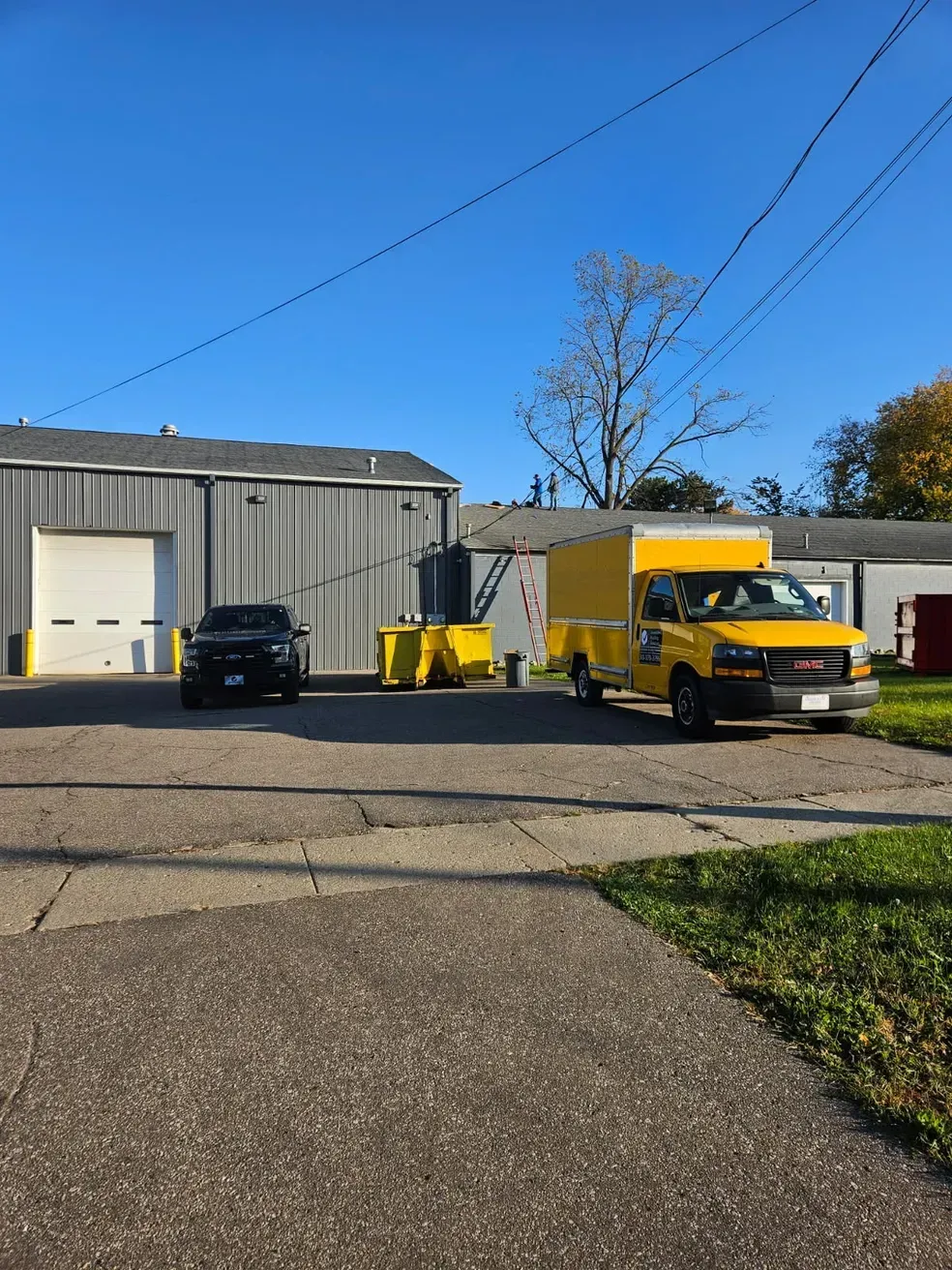 A yellow truck is parked in front of a building