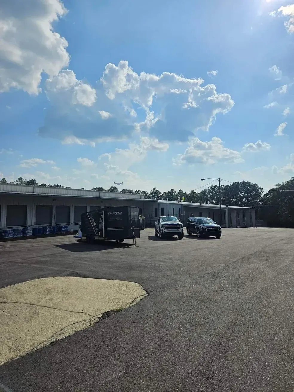 A parking lot with cars parked in front of a building
