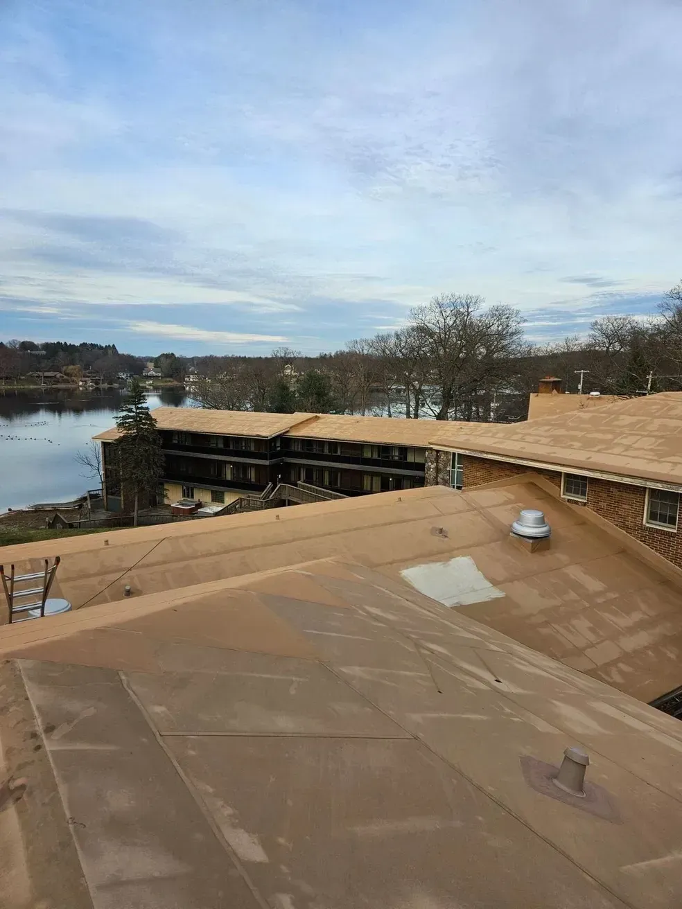 A roof of a building with a view of a lake.