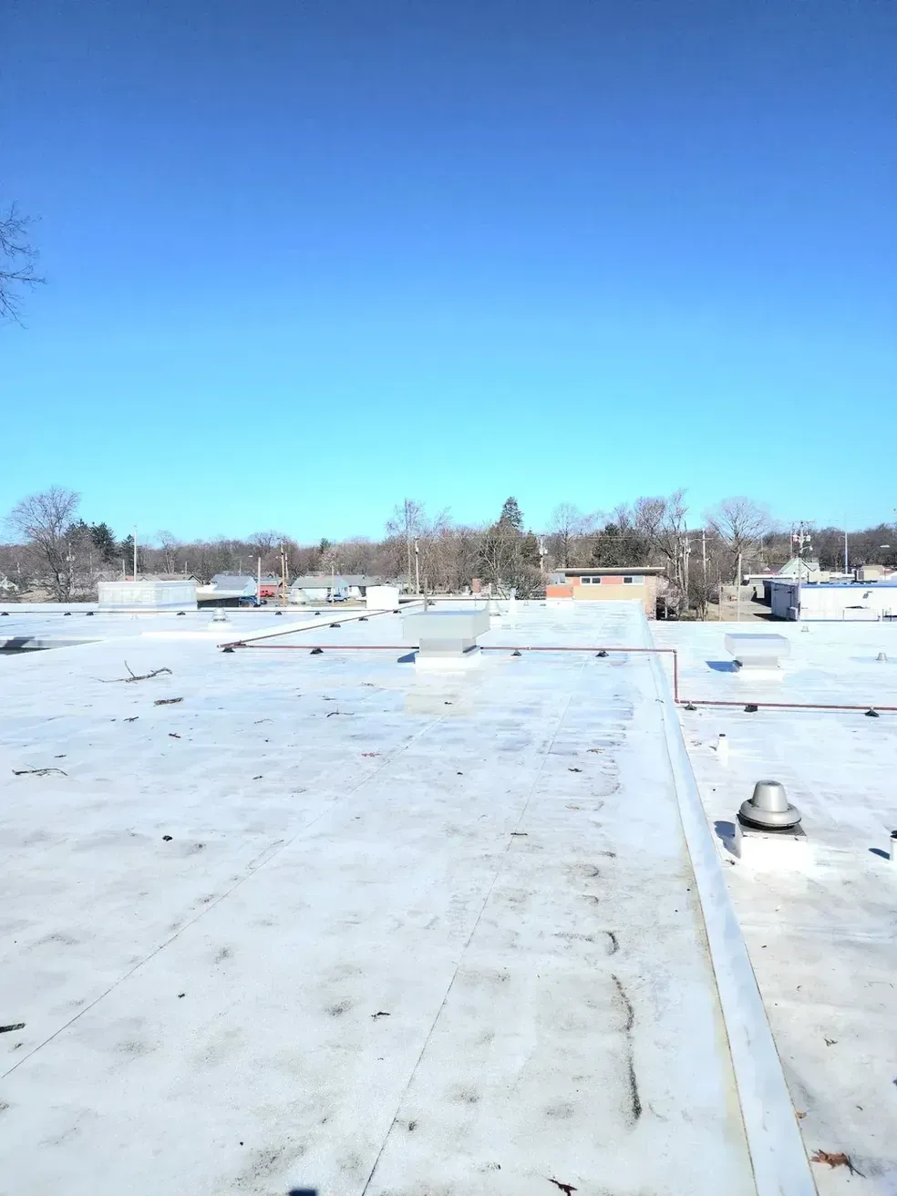 A white roof with a blue sky in the background
