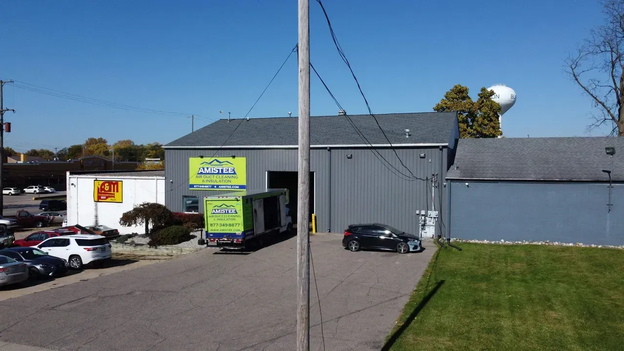 An aerial view of a building with a water tower in the background.