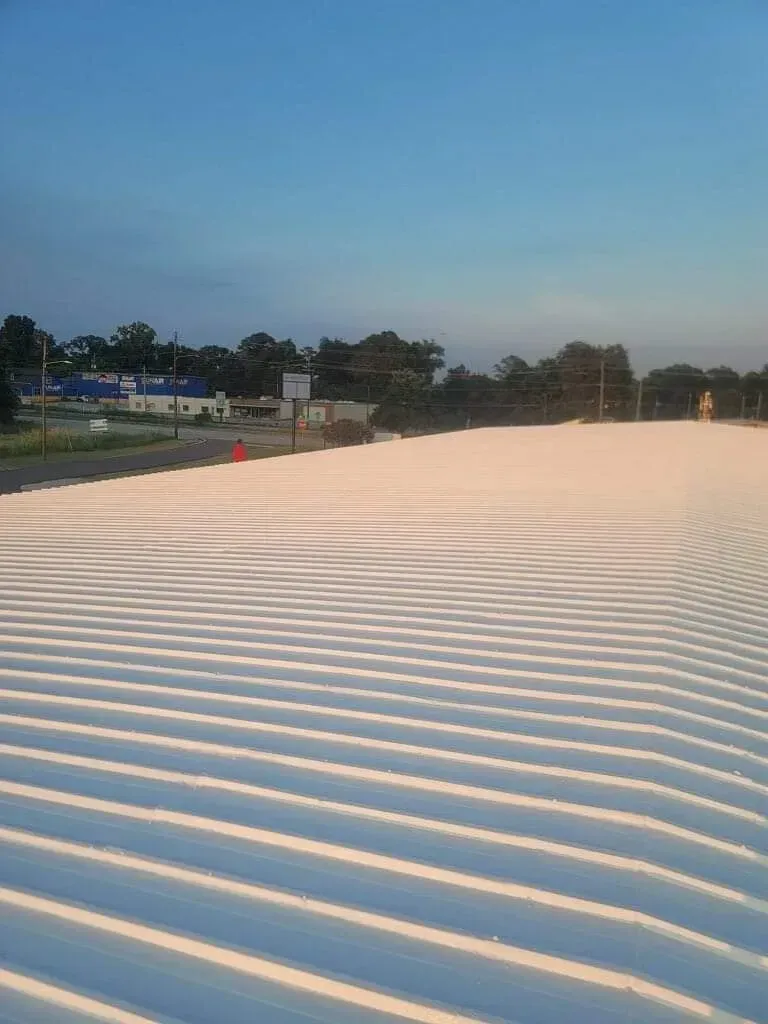 A large white roof with a blue sky in the background
