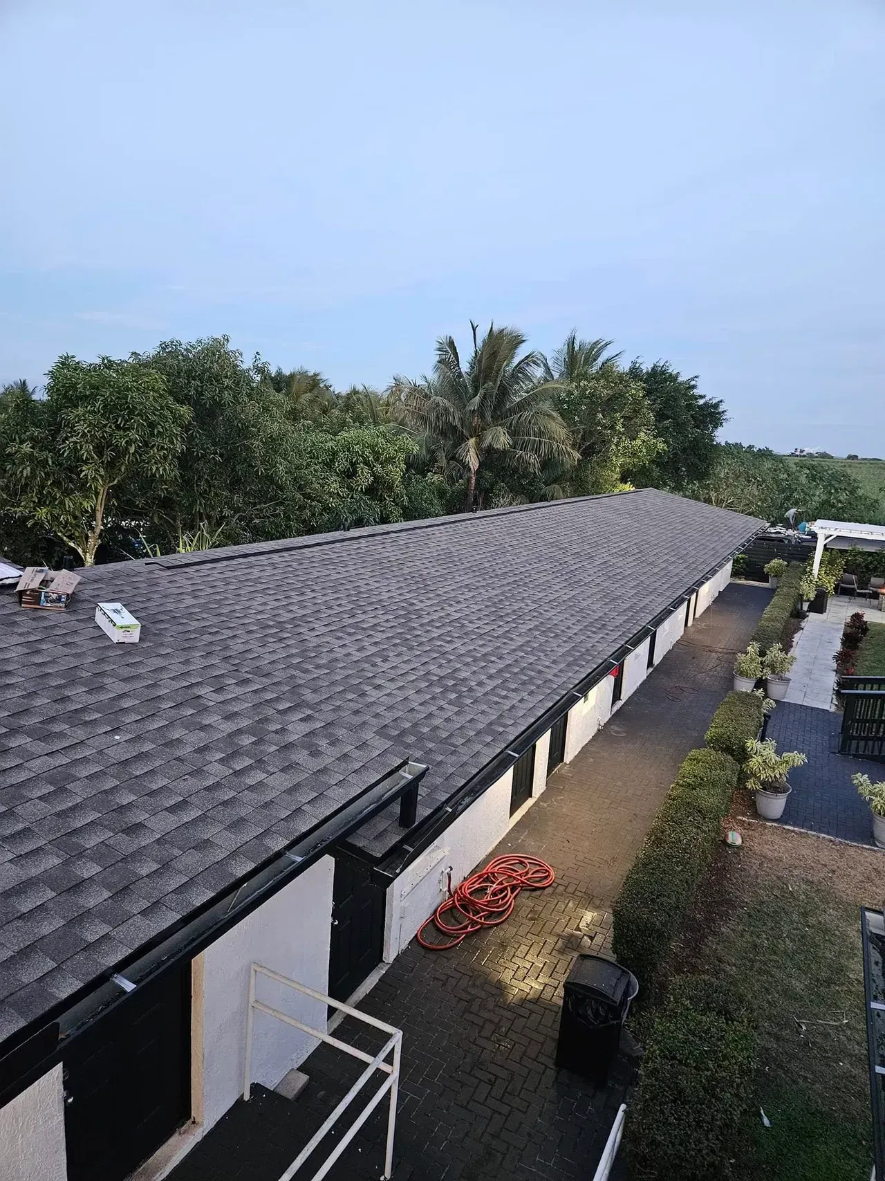 An aerial view of a house with a roof that is being installed.